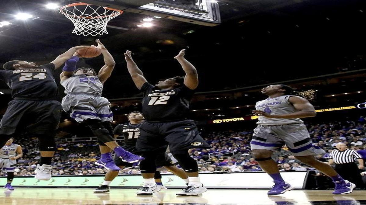 Kansas State’s Wesley Iwundu (center) got between Missouri’s Kevin Puryear (left) and Namon Wright (12) for a shot in the first half at the Sprint Center.