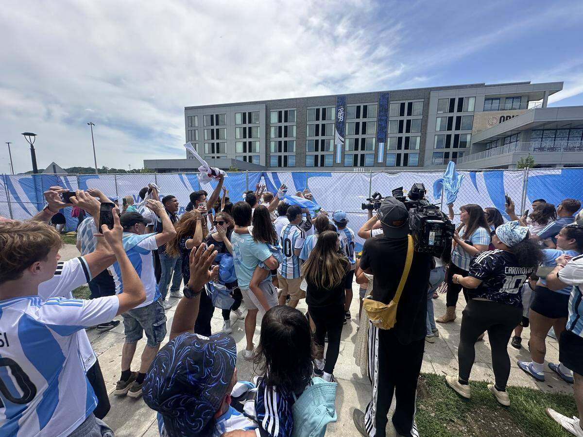 Argentina fans sing and cheer outside of Origin Hotel on the riverfront as members of Team Argentina check into the hotel for the first time in their World Cup preparations. Argentina landed in Kansas City on Sunday morning.