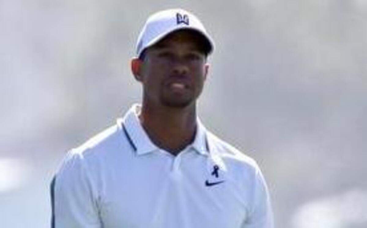 
Tiger Woods appeared frustrated after his short approach shot missed the green on the 10th hole of the north course at Torrey Pines during the first round of the Farmer Insurance Open golf tournament on Feb. 5 in San Diego. Woods later withdrew from the tournament with back problems. 
