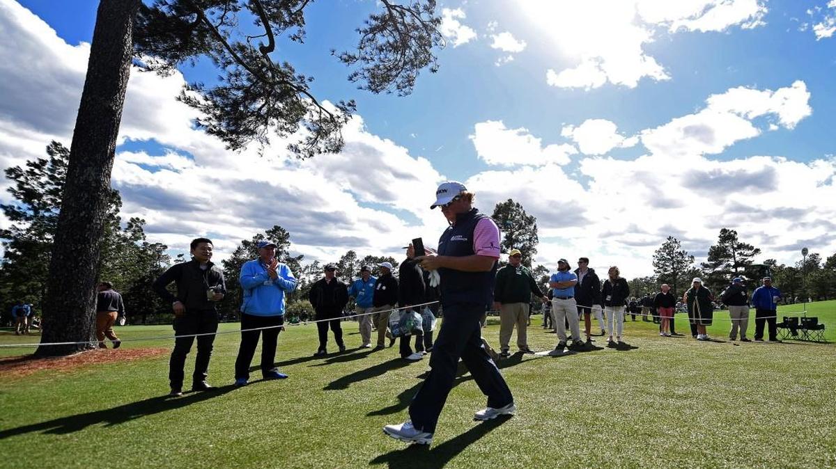 William McGirt looks over his yardage book as he walks to the 18th tee box during the first round of the Masters at Augusta National Golf Club on Thursday. McGirt finished the round at -3.
