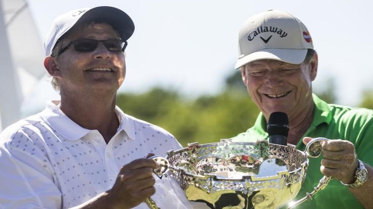 Tom Watson (right) handed the trophy to Rob Wilkin after Wilkin won the Watson Challenge on Sunday at Hallbrook Country Club.