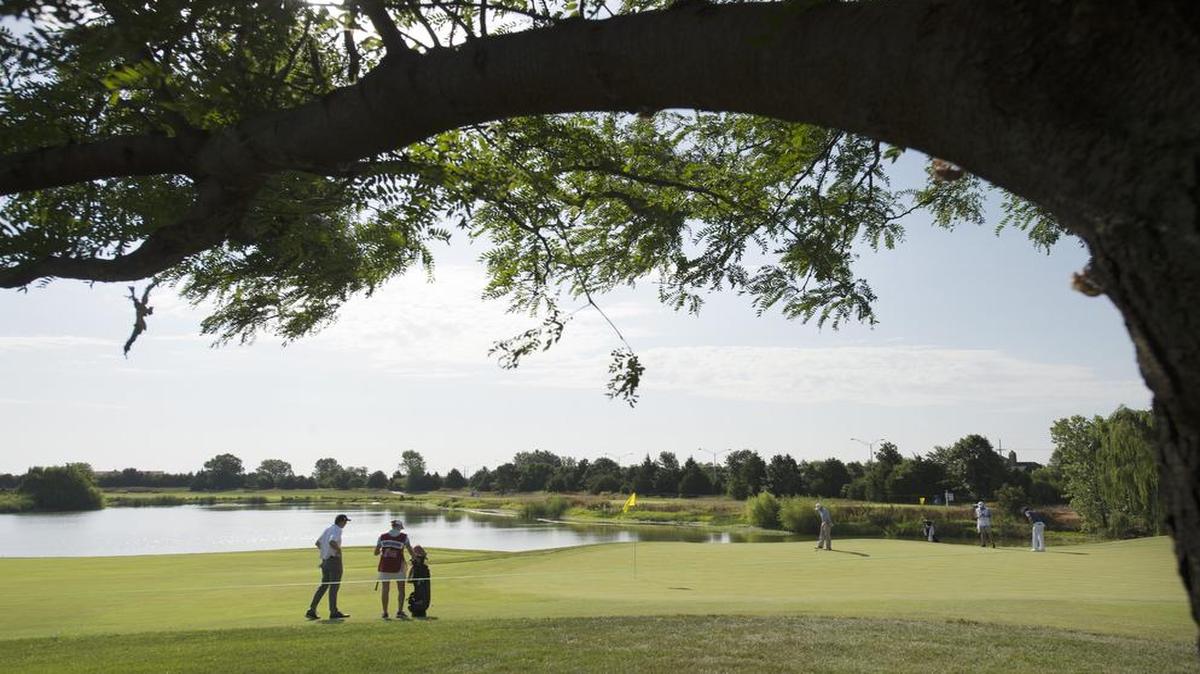 Korbin Kuehn of Overland Park, Kan., (left) waited for other players to hit a shot during the first round of the 2016 Digital Ally Open on the Web.com Tour at the Nicklaus Golf Club at LionsGate in Overland Park, Kan.