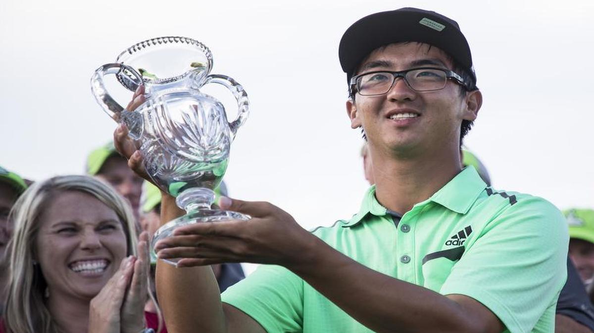 Zecheng Dou held up the trophy he received for winning the Web.com Tour’s Digital Ally Open on Sunday at Nicklaus Golf Club at LionsGate in Overland Park. He’s not only the first Chinese player to win on the tour, he will also be the first to earn a PGA Tour card.