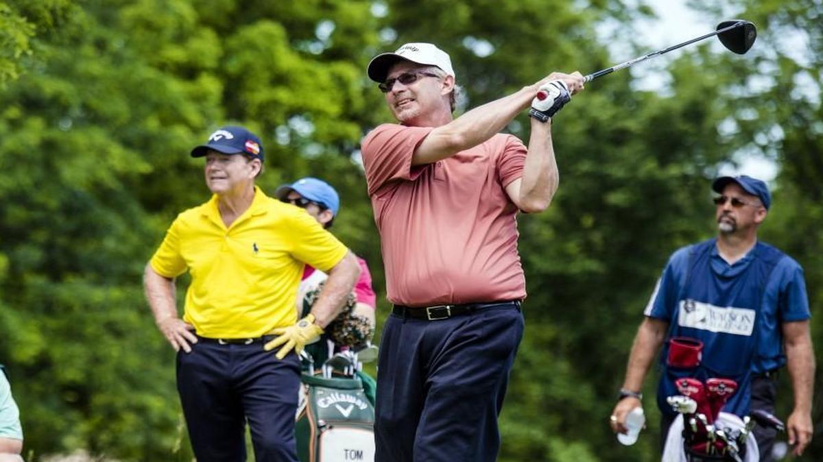 Rob Wilkin teed off while being watched by Tom Watson during the second round of the Watson Challenge on Saturday at Hallbrook Country Club.