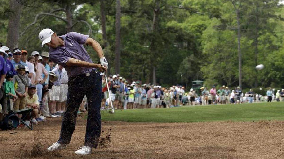 
Jordan Spieth hit out of the rough on the 14th hole Friday. He has posted the lowest 36-hole score in Masters history: 14-under.
