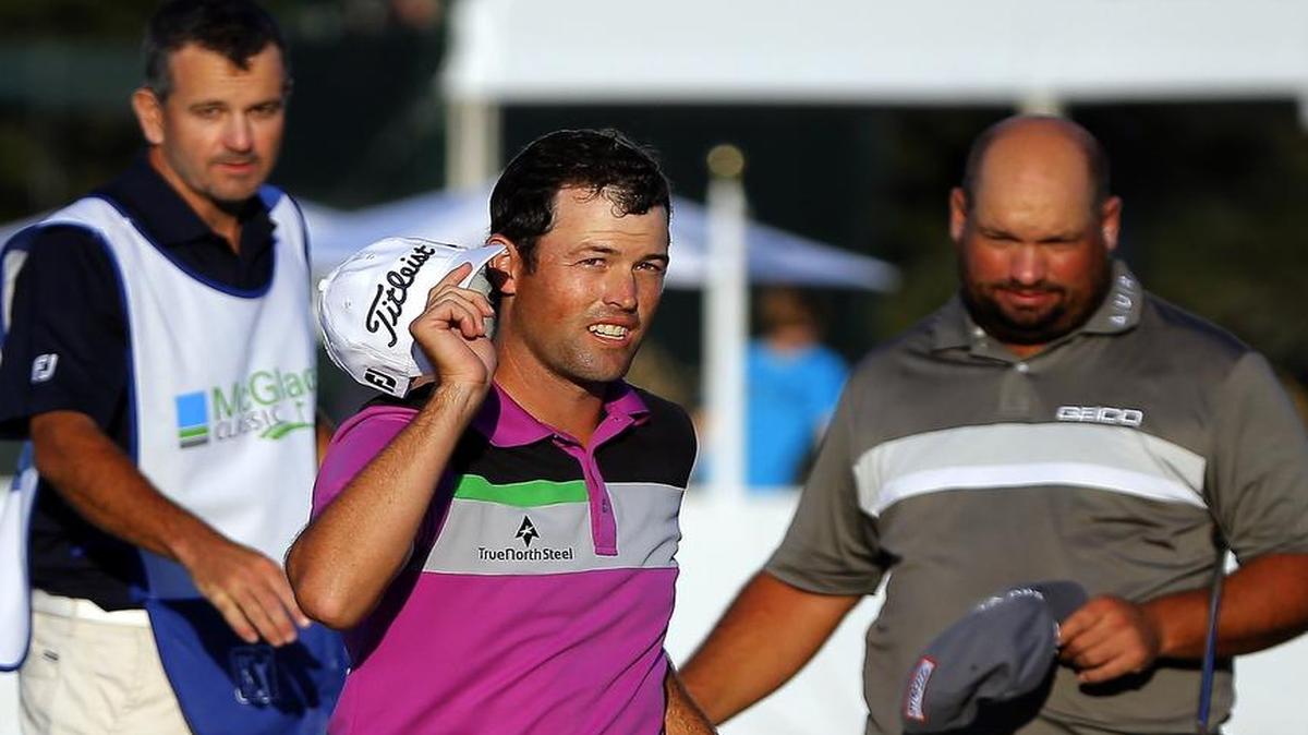 
Robert Streb (center) waved to the crowd after winning a three-way playoff during the final round of the McGladrey Classic golf tournament on Oct. 26 in St. Simons Island, Ga. Streb beat Brednon de Jonge (right) and Will MacKenzie. 
