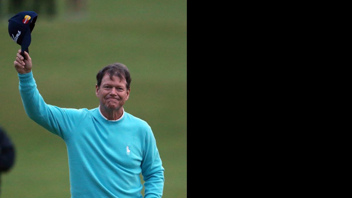 
Tom Watson tips his cap to the thousands of spectators who hung around well into the night to watch the 65-year-old golfing legend wrap up his British Open career on the 18th green at St. Andrews in Scotland. 
