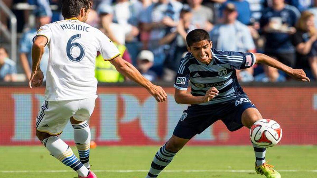
Igor Juliao (40) of Sporting Kansas City controls the ball against Baggio Husidic (6) of the LA Galaxy in Kansas City, Kansas, at Sporting Park on Saturday, July 19, 2014. 

