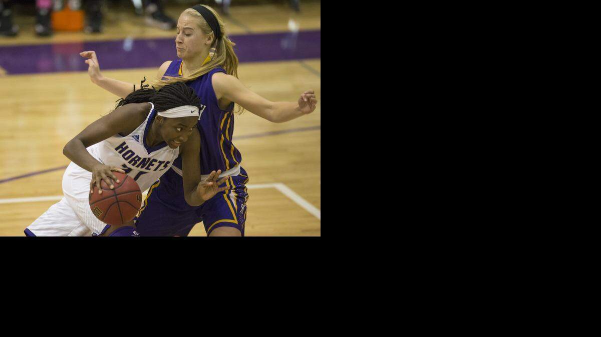 
Maya Brewer (with ball) of North Kansas City looked for an opening around the defense of Kearney’s Elizabeth McQueen during their first-round game of the Northland Classic on Monday at North Kansas City High School. The Hornets defeated Kearney, 45-34.
