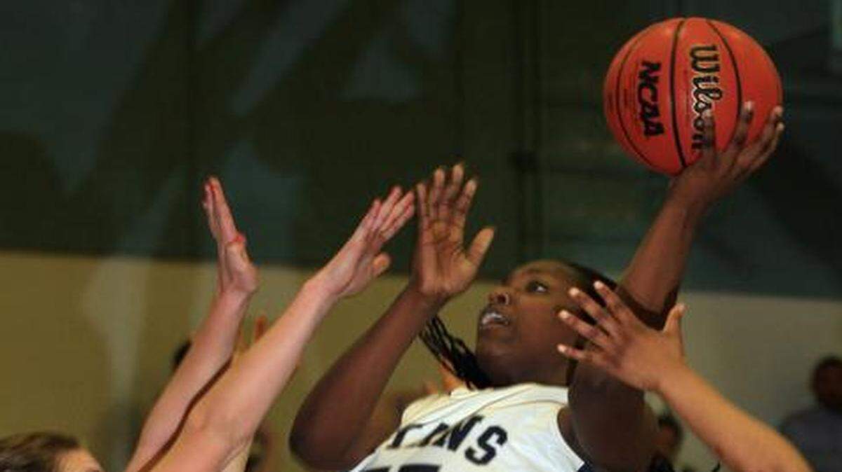 
Lee's Summit West’s De’Jionae Calloway (with ball) put up a shot in a game against St. Teresa’s Academy last season. Calloway finished the game 16 points.
