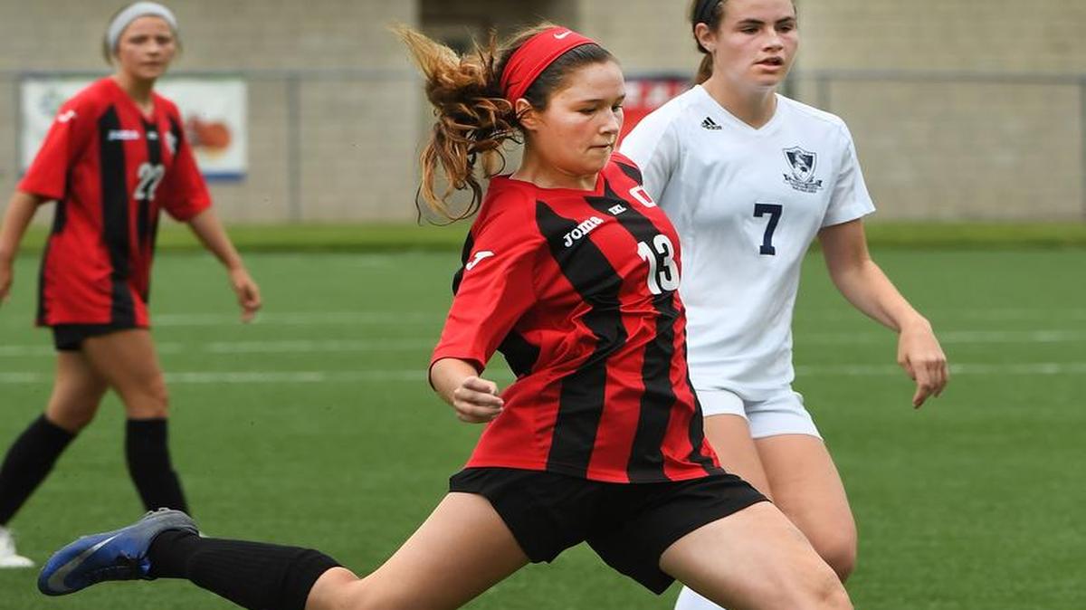 Blue Valley West’s Peyton Kennedy (left) scored a goal against Blue Valley North in the Kansas Class 6A girls soccer state championship game Saturday.