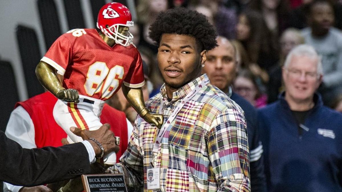Chester Graves, a senior defensive lineman at Park Hill, holds up the Buck Buchanan Memorial Award he received as the best lineman or linebacker in the Kansas City area. Graves was also a finalist for the Simone Award.