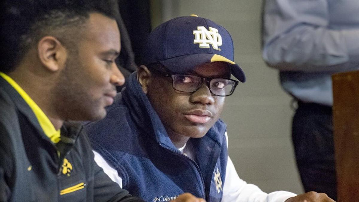 Bishop Miege wide receiver Jafar Armstrong looked at his teammate cornerback Djimon Colbert, who signed with the University of Iowa, on Wednesday as he signed a letter of intent to play college football for the University of Notre Dame, surrounded by friends and family at the high school's auditorium. The highly recruited player committed in June to attend the University of Missouri but changed his mind on Sunday, switching to the Fighting Irish.