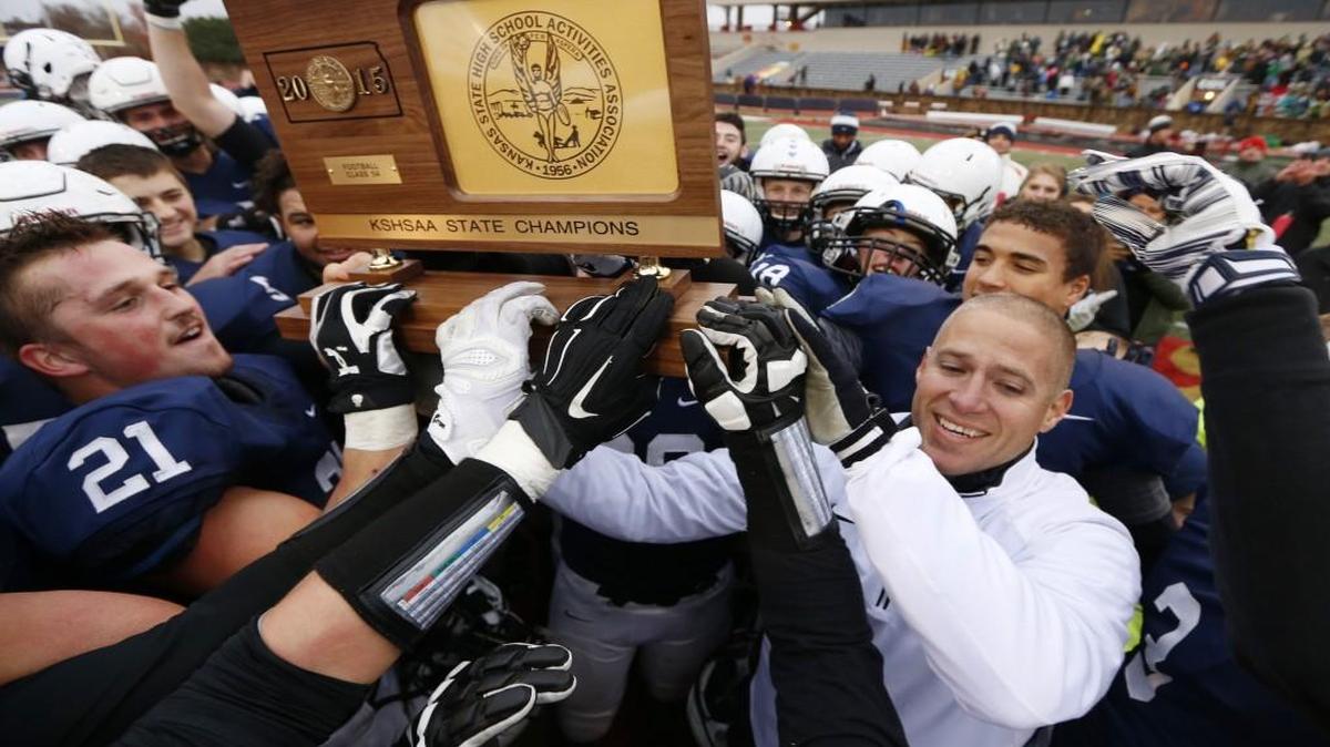 Mill Valley head coach Joel Applebee celebrated the state championship with his players.