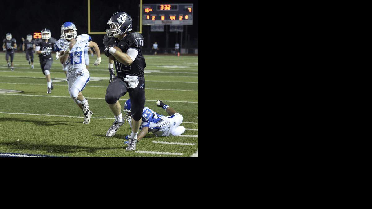 
Lee's Summit West senior Brenner Clemons (with ball) scores a second-quarter touchdown past Liberty’s Kaiden Hullett (No. 25) and Steven Steven Marion (No. 33) during Friday's high school football game at Lee's Summit West.
