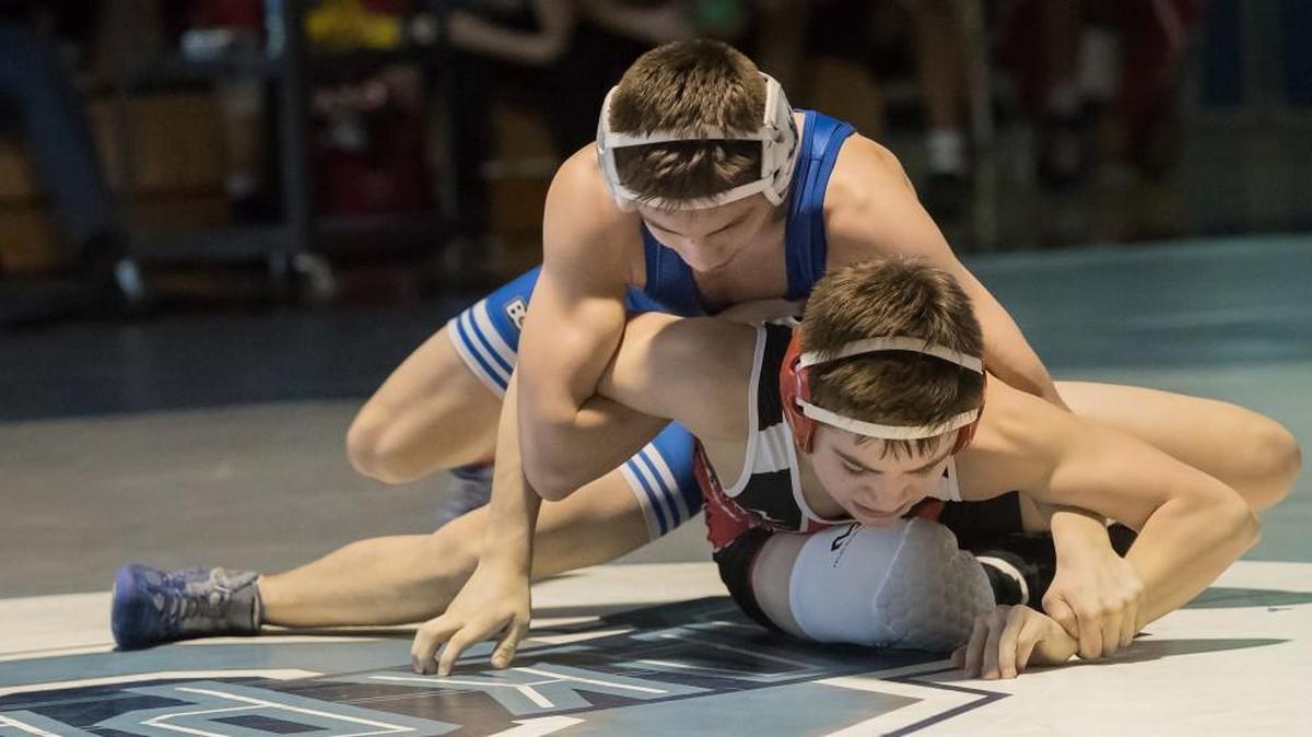 Jeremiah Reno, of Liberty, (top), and Try Crawford, of Park Hill, battle for first palce in the 106-pound weight class at the Class 4 District 4 wrestling tournament Saturday at Oak Park. Jeremiah won the match and took a 40-0 record into the state tournament.