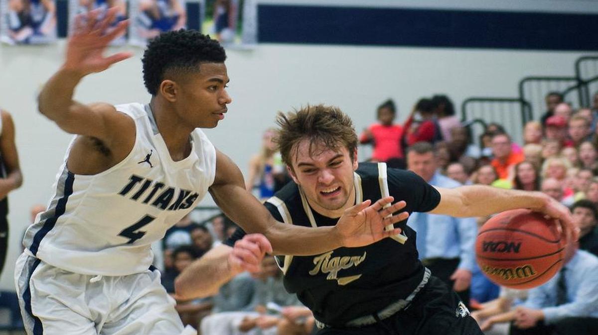 Lee’s Summit’s Blake Spellman (right), who scored 25 points Friday, tried to drive around Lee’s Summit West’s Phillip Brooks in the second half.