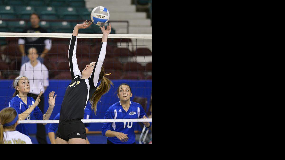 
Blue Valley’s Kennedy Etheridge (center) focused on the volleyball in front of Olathe Northwest players Tyanna Omazic (left) and Madeline Schneider (right, No. 10), who prepared to react during the 2013 Kansas state tournament. Schneider is the Sunflower League player of the year and Omazic is a first-team member.
