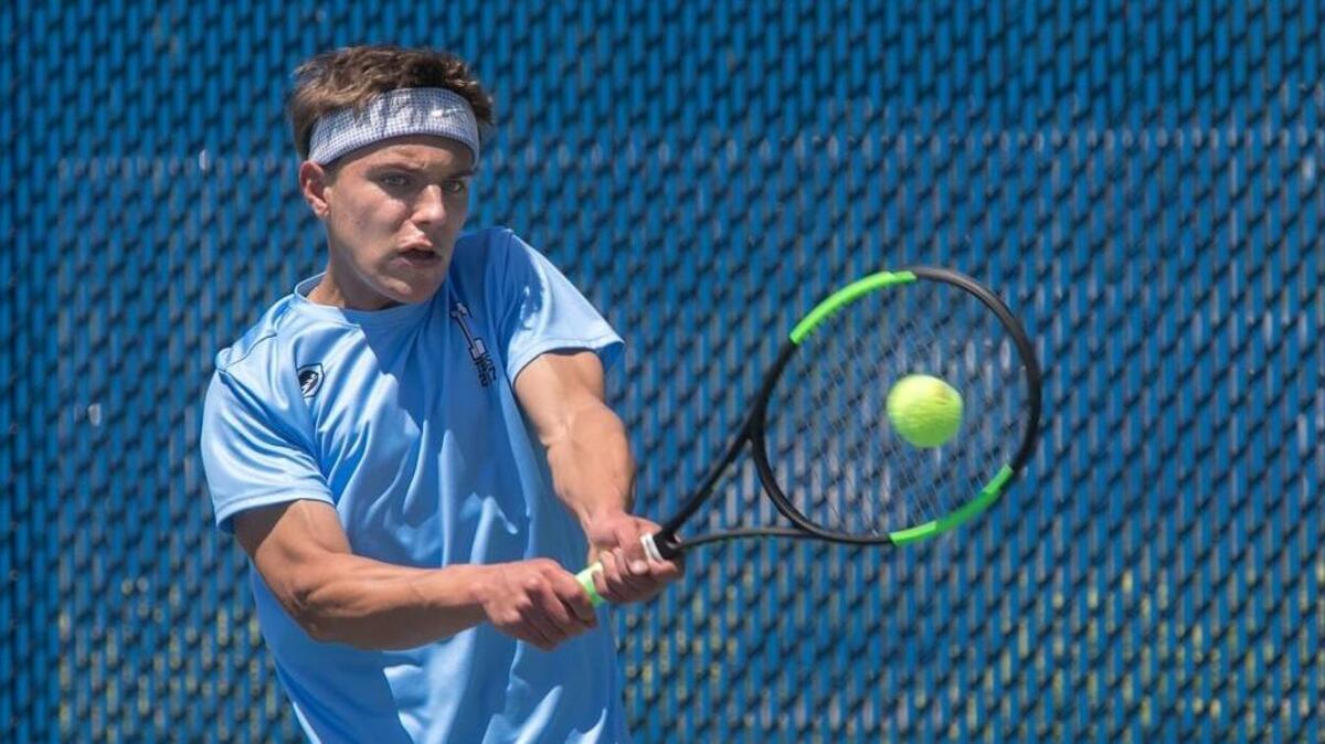 Billy Louiselle, a junior at Shawnee Mission East, returns a shot against Bryce Easton of Manhattan Friday during the first day of the Kansas Class 6A state boys tennis tournament at the College Boulevard Activity Center in Olathe. Louiselle finished in fourth place.