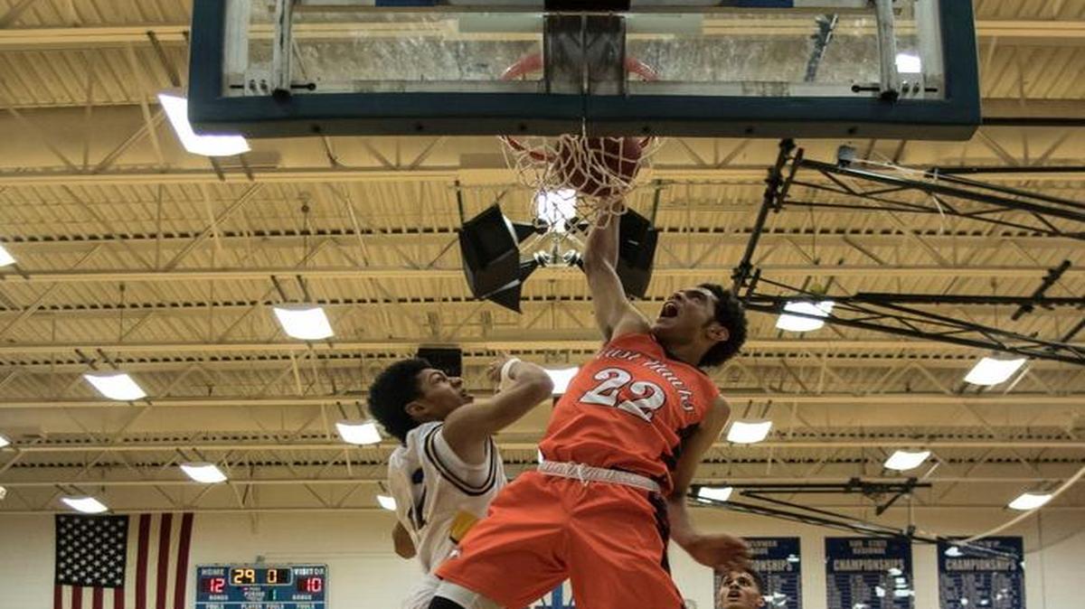 Olathe East’s Cameron Hunter got to the basket in traffic and slammed home two points for the Hawks.