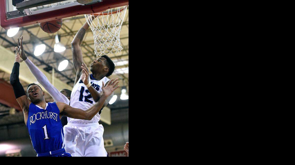 
Raytown forward Jailen Gill blocked a shot by Rockhurst’s Cartier Dean during a game Monday.
