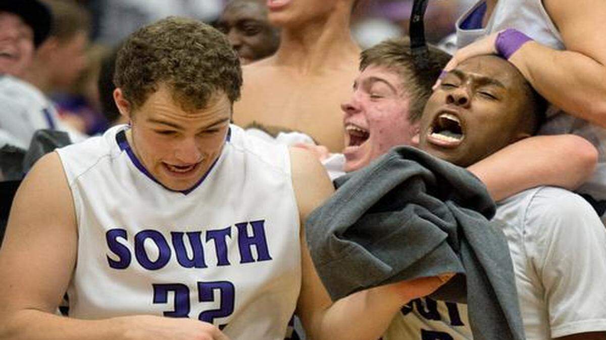 
Park Hill South players Shaefer Schuetz (left) and James Byrd got caught up in a celebration by fans at the end of a 61-58 win over Park Hill on Friday night.


