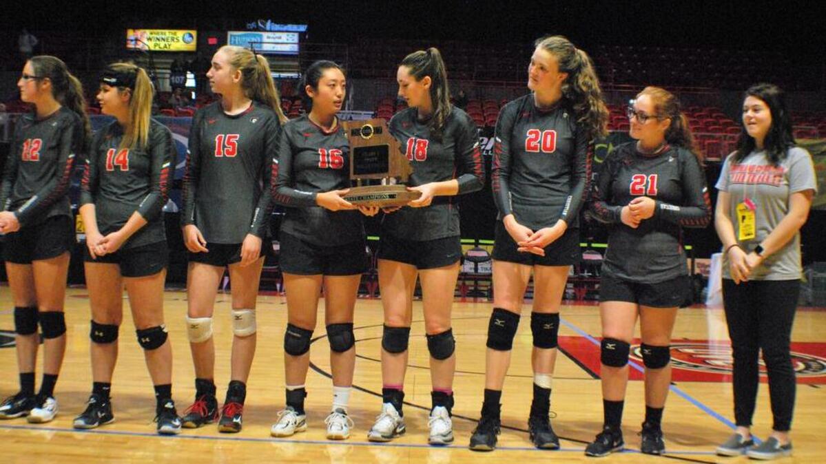 Northland Christian's Ruoqung Xu (16) and Rachel Sturdevant (18) hold the Class 1 state championship trophy after the Trailblazers defeated New Haven in straight sets Saturday, Oct. 28, 2017, at the Show Me Center in Cape Girardeau, Mo.