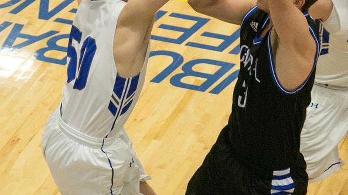 Alex Tison of Liberty (left) tried to shoot past Landon Grundberg of St. Joseph Central. Tison scored nine points in Liberty’s 52-50 victory on its home floor.