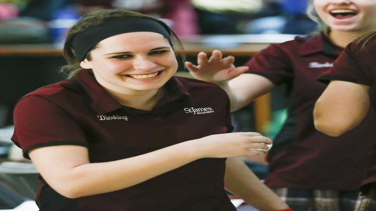 Alanna Dirking of St. James Academy gets congratulations after finishing first in the individual title at the Kansas 5-1A state bowling championships in Wichita. St. James also won a team trophy.