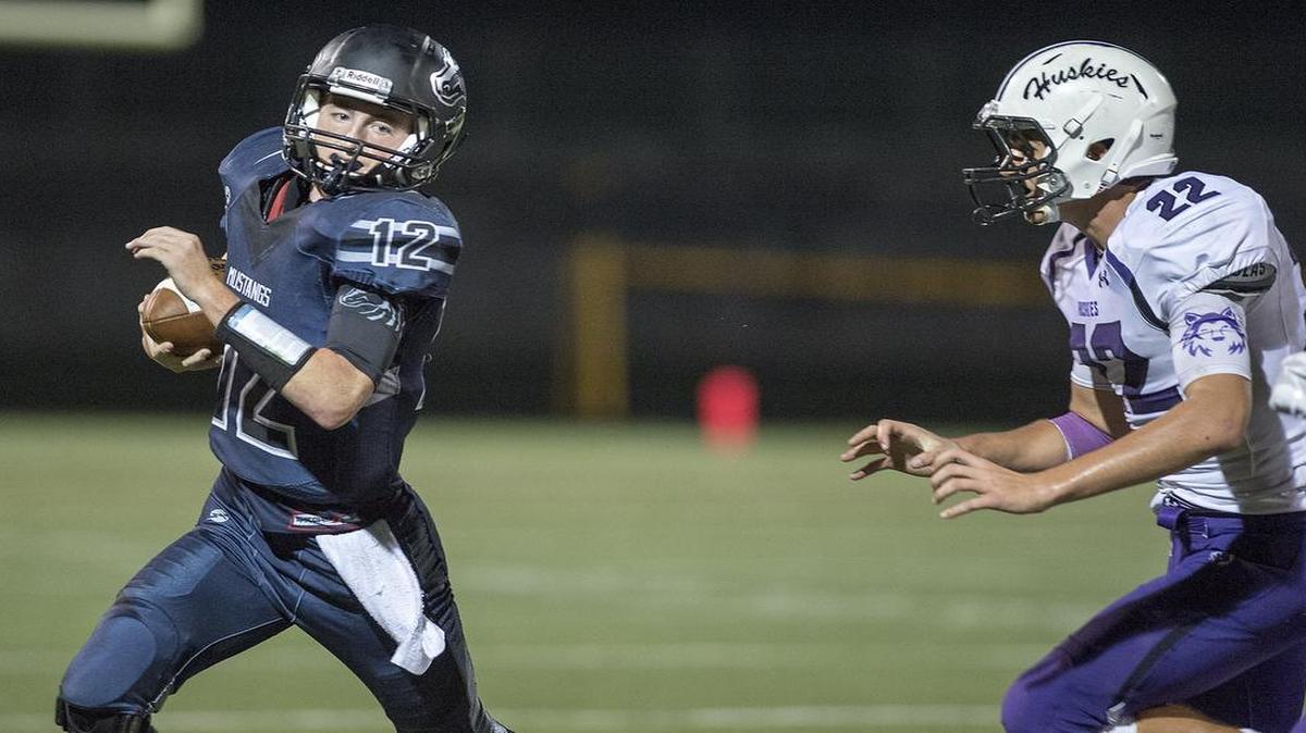 Quarterback Joey Dolan (left) and his Blue Valley North teammates play Olathe North in a battle of 8-1 teams on Friday night in the Kansas Class 6A football regional playoffs.