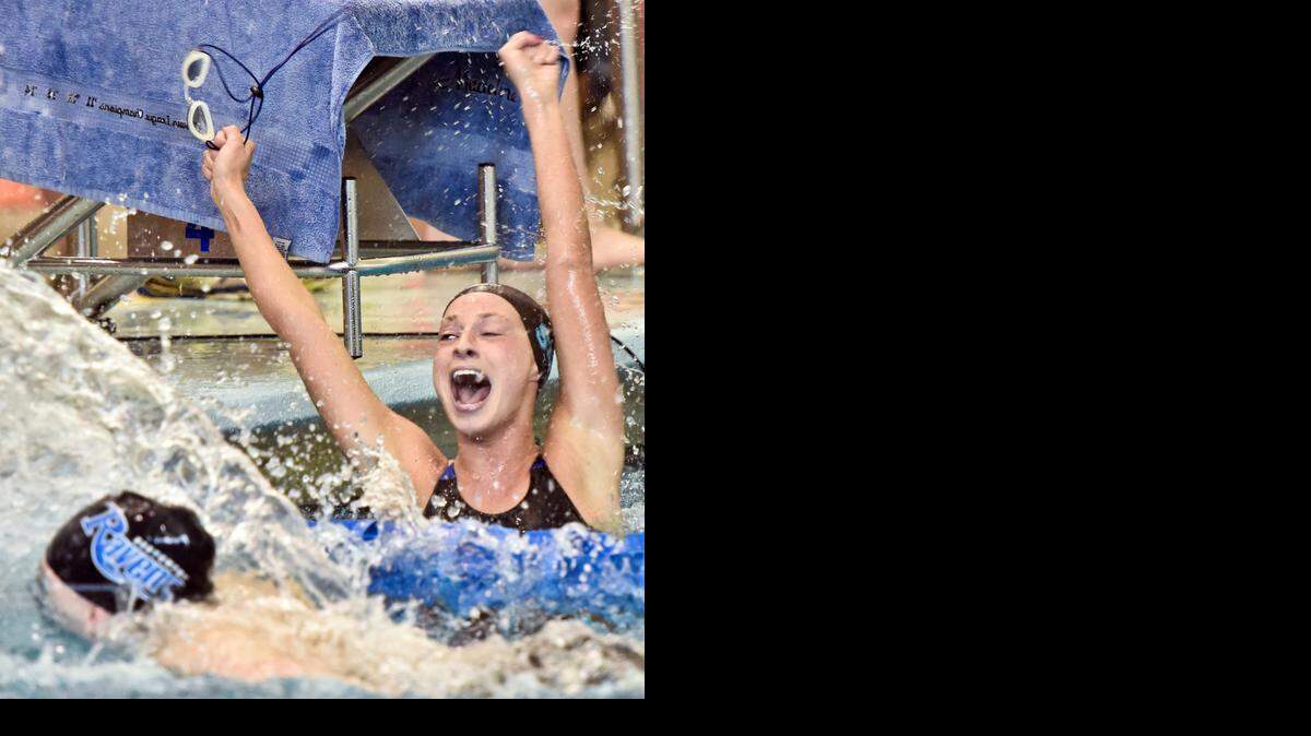 
SM East’s Madeline Peters raised her arms in triumph after her team won the 200 medley on Saturday.
