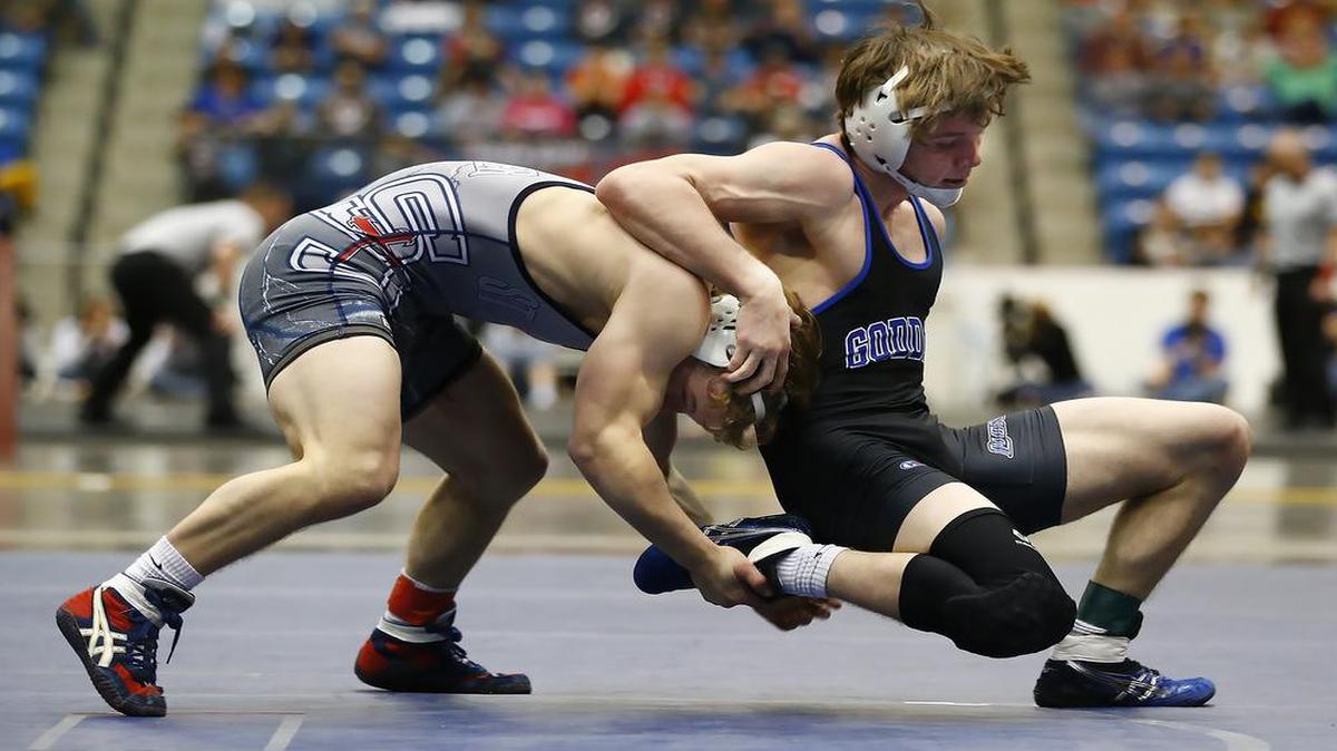 Stephen Tujague (left) of St. James Academy defeated Goddard’s Garrett Lange in the Kansas Class 5A 138-pound state title match on Saturday.