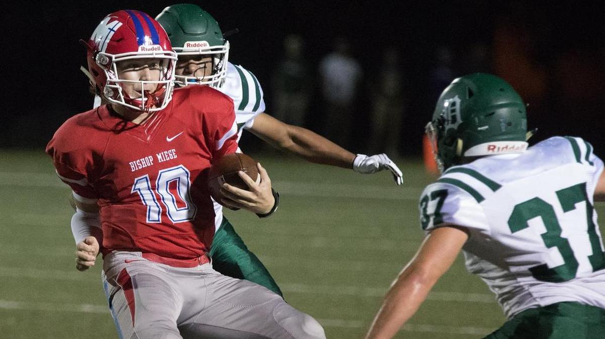 Bishop Miege quarterback Carter Putz (left) helped his team earn a 31-0 win over De Soto on Friday night at Bishop Miege.