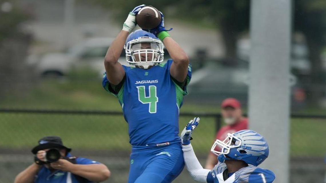 Briley Moore-McKinney of Blue Springs South soared high for a catch over defender Josh Watson of Liberty during a high school football jamboree prior to the 2014 season.