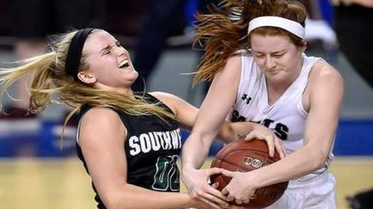 
Blue Valley Southwest’s Rilynne Like (left) and Rhyann Fisher of St. Thomas Aquinas battled for the ball in the second half of their Kansas Class 5A state semifinal game on Friday in Wichita. Blue Valley Southwest defeated Aquinas, 42-31. 

