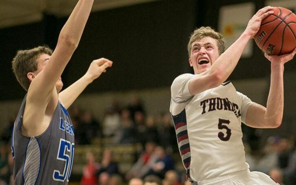 St. James Academy junior guard Zach Thornhill shot over Liberty’s Alex Tison in the Thunder’s 77-71 overtime win in the Best of the Midwest Showcase on Saturday. Thornhill scored a game-high 31 points.