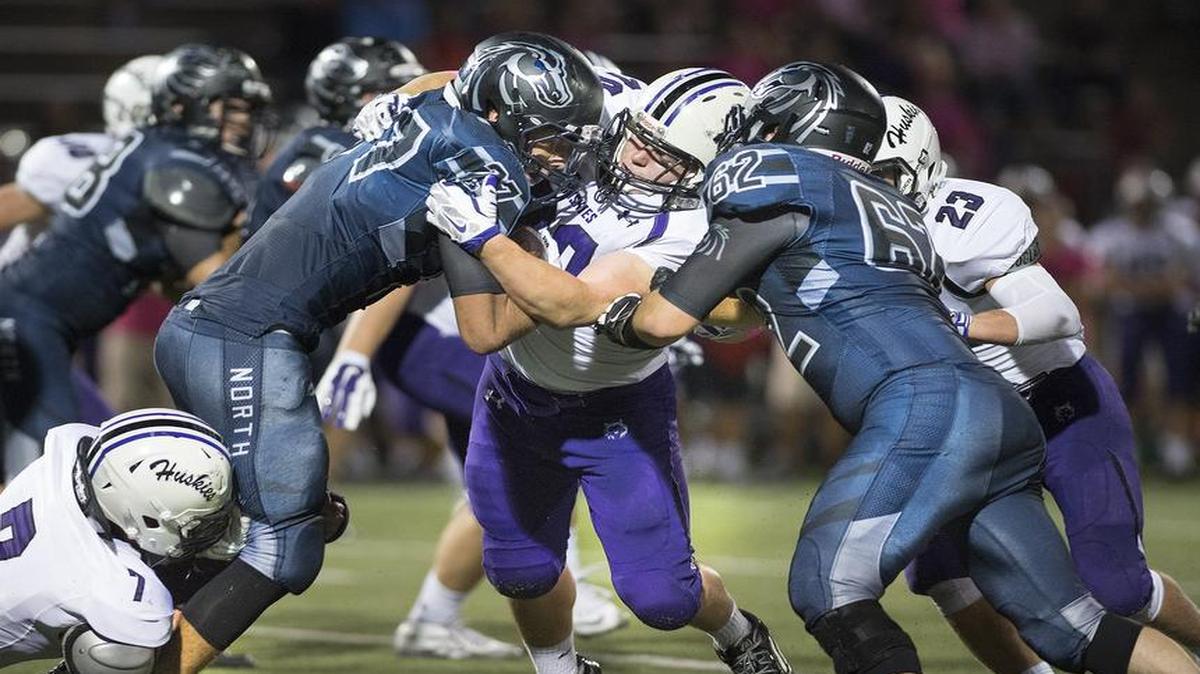 
Blue Valley North’s Cooper Lantefield (No. 27) and teammate Tyler Koenig stopped Blue Valley Northwest quarterback Jack Knutson during their game on Friday night.
