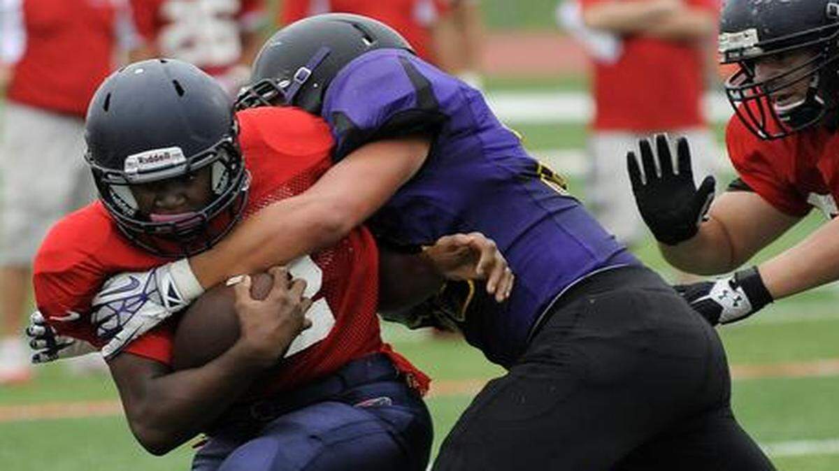 
Truman High School running back Jordan Salima (with ball), seen here in a preseason jamboree, had to adjust his role last week for Patriots, when their starting quarterback was injured.
