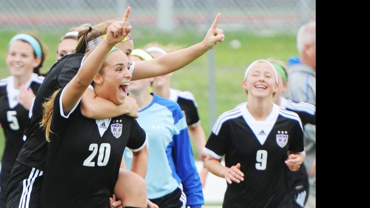 
Blue Valley Northwest’s Lauren Beischel (front left) carried teammate Caroline Kerns and Sophie Connor (right) joined the celebration after the Huskies won the Kansas 6A girls soccer state title.
