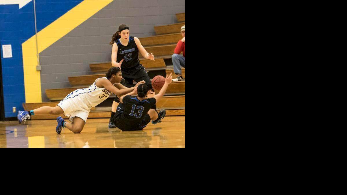 
South's Dejanae Roebuck dives to try and intercept this pass from Leavenworth's Alicia Brown to team mate Rachel Blackburn at the basketball game between Olathe South and Leavenworth High Schools at Olathe South High School in Olathe, Ks. on February 6, 2015. Leavenworth won 47-34.
