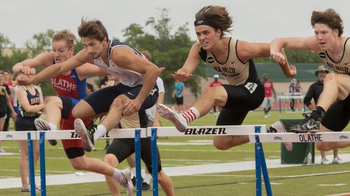 Jacob Large (left) of Olathe North, Nathan Lucas of Olathe East and Dominic Legato and Brody Jacobsen of Blue Valley, compete in the boys 110-meter hurdles final during the Kansas Class 6A regional track meet Thursday at the Olathe District Activities Center. Legato won the race.