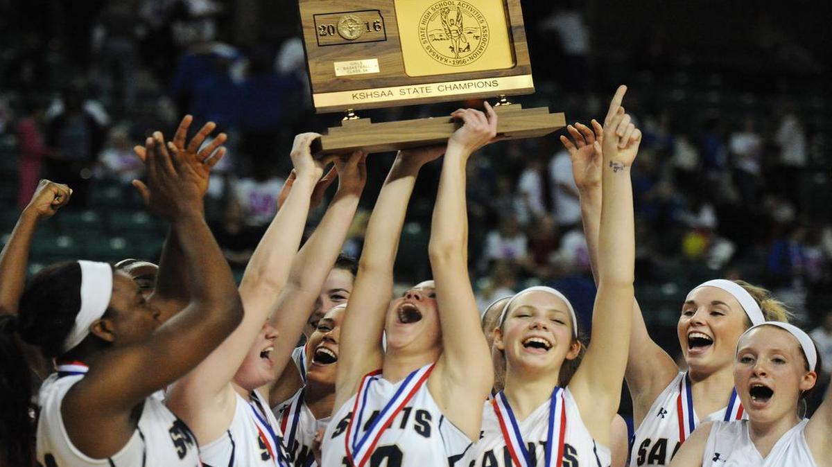 Members of St. Thomas Aquinas celebrated their 39-38 victory over Leavenworth and their Kansas Class 5A state championship trophy on Saturday in Topeka.