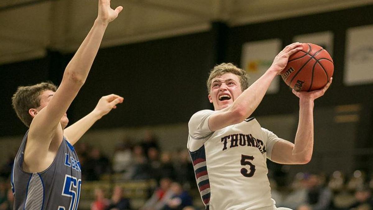 St. James Academy junior guard Zach Thornhill (with ball) goes up for a shot against Alex Tison of Liberty during their game on Saturday in the 810 Varsity Best of the Midwest Showcast at Johnson County Community College. St. James Academy won the game, 77-71, in overtime and Thornhill scored a game-high 31 points.