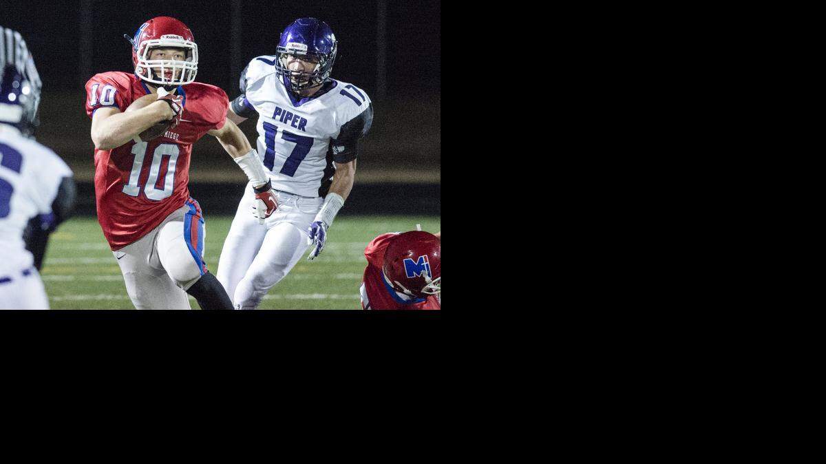 
Dawson Downing (with ball) of Bishop Miege meandered through the Piper defense last week during their Kansas Class 4A Division I substate playoff football at Bishop Miege High School.

