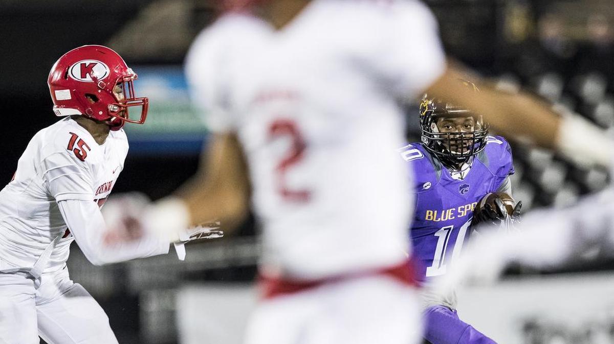Blue Springs’ Tre Wheaton tried to get away from Kirkwood’s Arvell Ferguson (left) in Friday’s Missouri Class 6 state championship game Friday in Columbia.