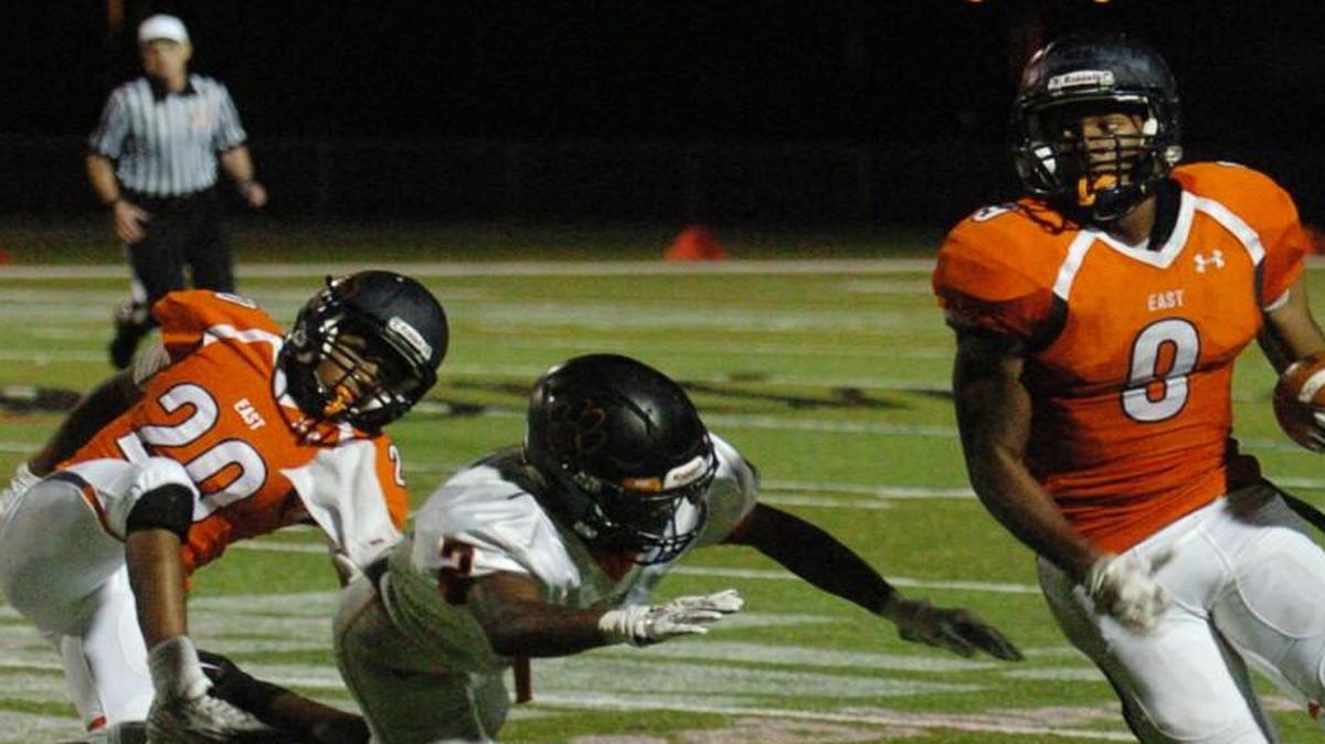 Olathe East’s Zac Cahill (right) was able to get past Shawnee Mission Northwest’s Jermaine Epps and around the corner in Thursday night’s game.