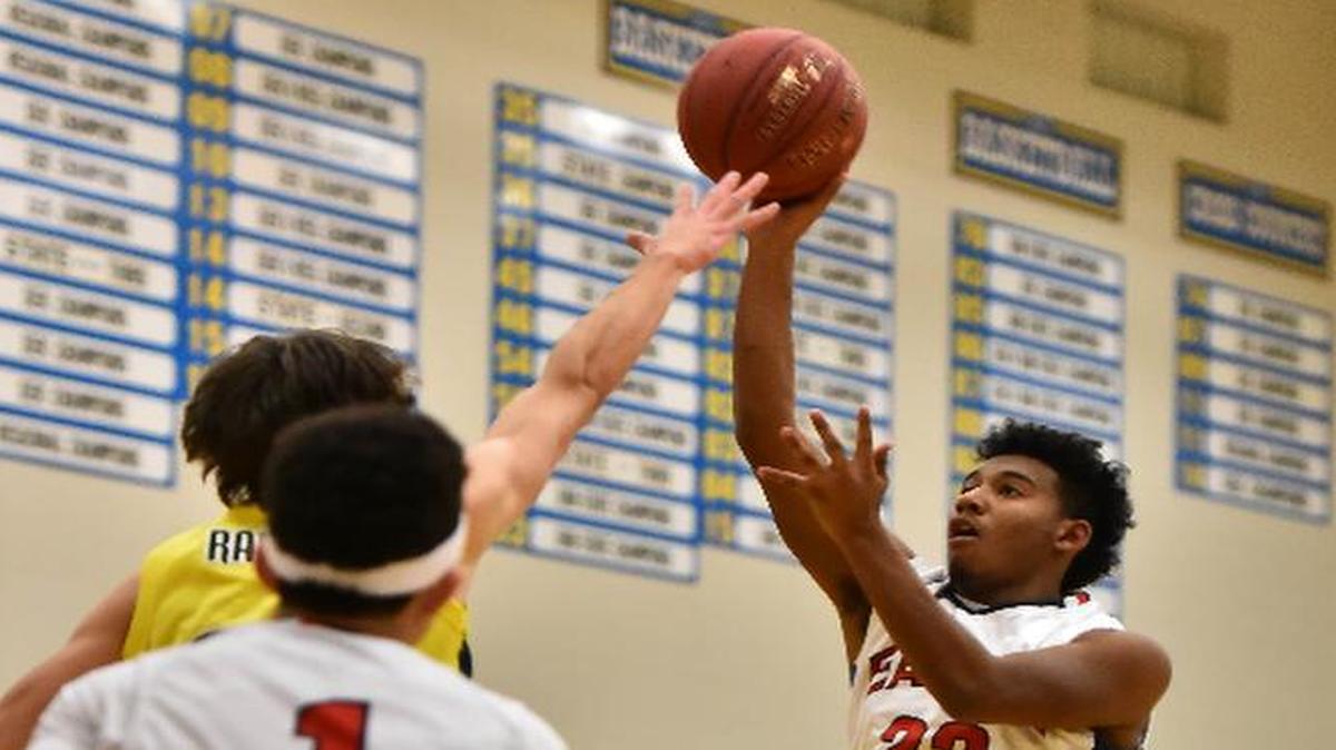 Olathe North senior Caleb Underwood put up a floater in the Eagles’ 62-49 victory over SM South last week in the championship game of the Ralph Miller Classic in Chanute, Kan.