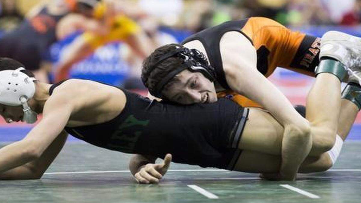 
Platte County’s Matthew Schmitt (right) admits to being extremely competitive, but it helped him win his first round Thursday at the Missouri Class 3 state meet.
