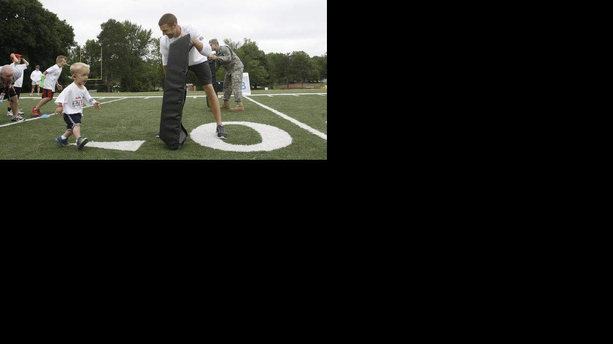
The Alex Smith Football ProCamp was held last weekend at Shawnee Mission West High School and involved about 250 kids. During one drill, Chiefs quarterback Alex Smith held the pad for Brice Pinter, of Lenexa, who celebrated his seventh birthday at the camp.
