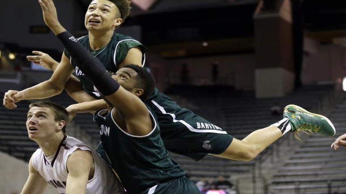 
Barstow’s Shea Rush (top) watched as his shot bounced off the rim while Rush fell into teammate Jeriah Horne and Strafford’s Kyle Tate during the Missouri Class 3 boys high school basketball championship game.
